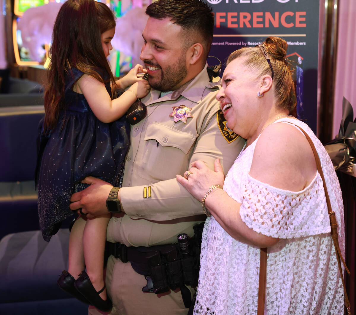 Las Vegas police officer Humberto Zarate is congratulated by his mother Elizabeth Zarate and da ...