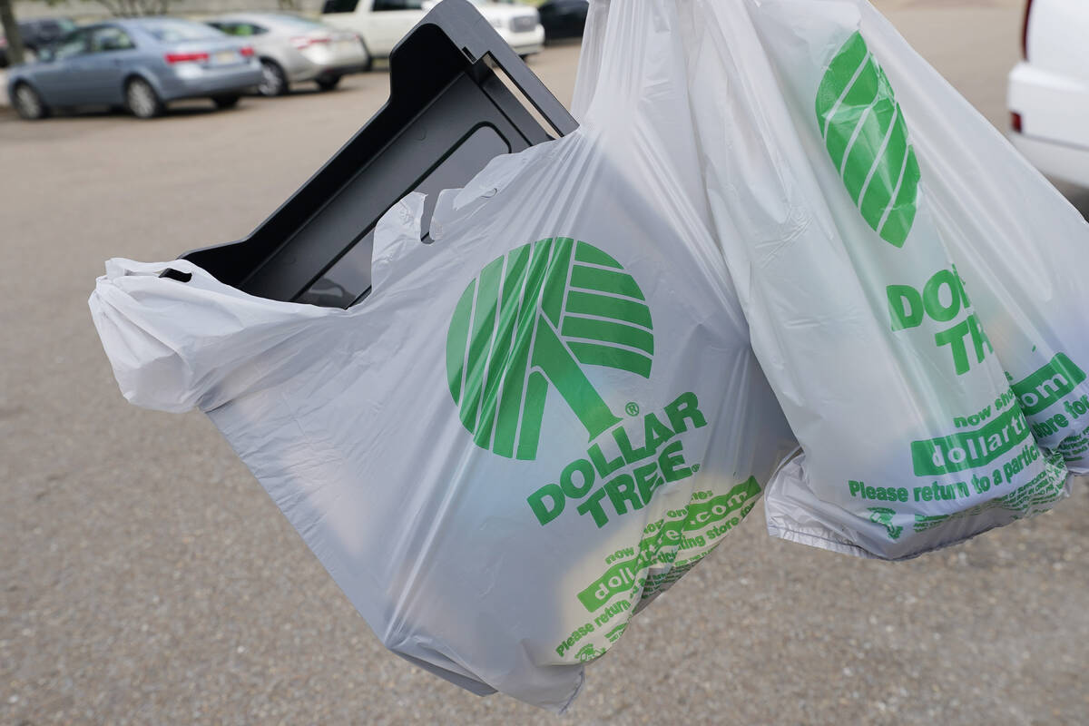 A customer exits a Dollar Tree store holding a shopping bag on Wednesday, May 11, 2022, in Jack ...