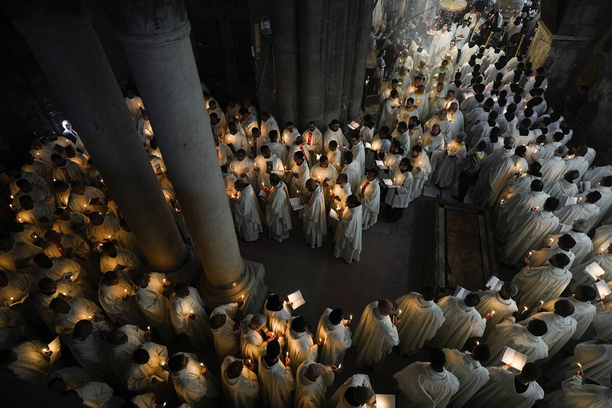 Catholic clergy hold candles as they walk during the Washing of the Feet procession at the Chur ...