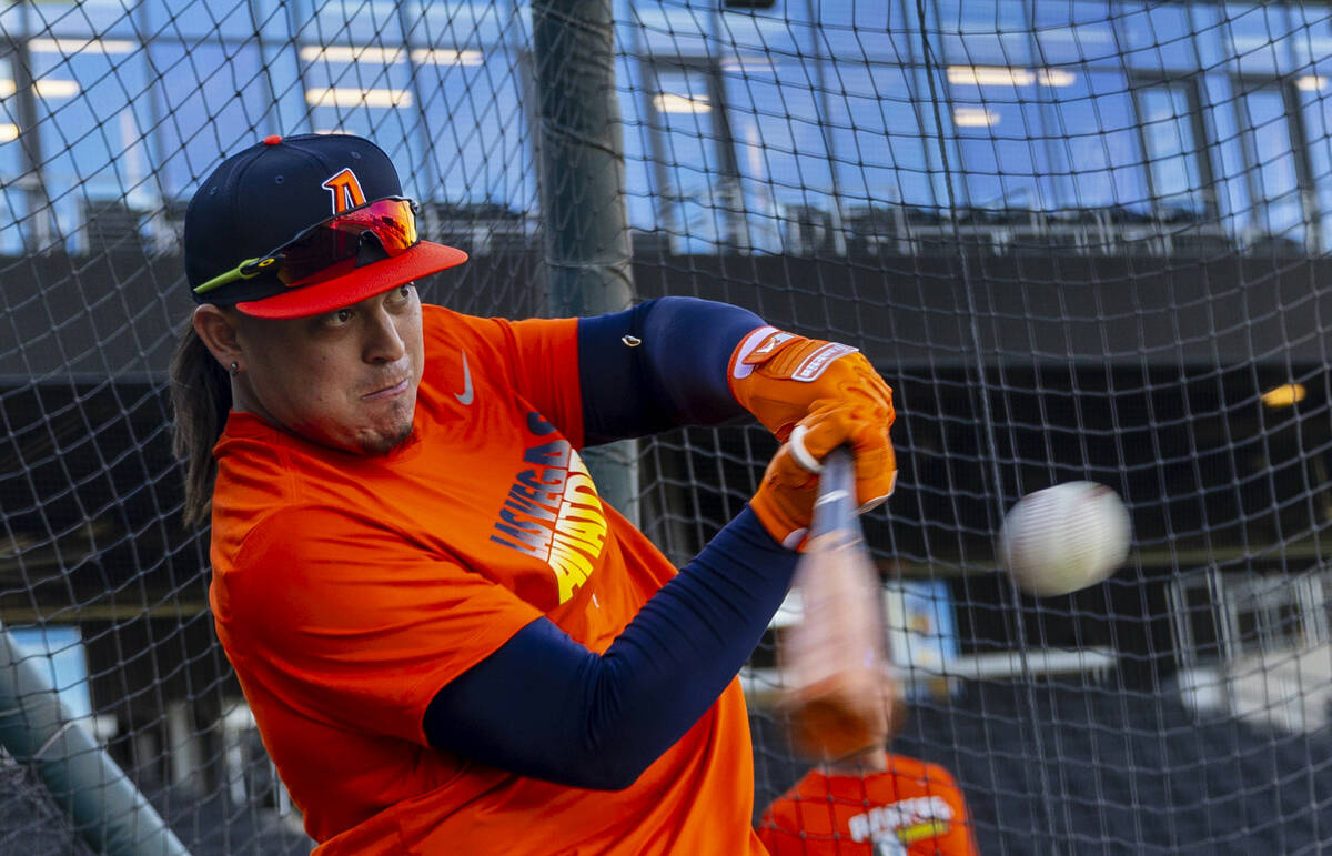 Catcher Yohel Bozo (37) crushes the ball while batting during practice at the Las Vegas Ballpar ...