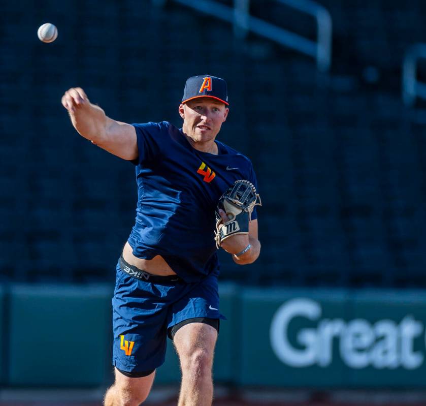 Infielder Brett Davis (23) tosses to first base during practice at the Las Vegas Ballpark on Tu ...