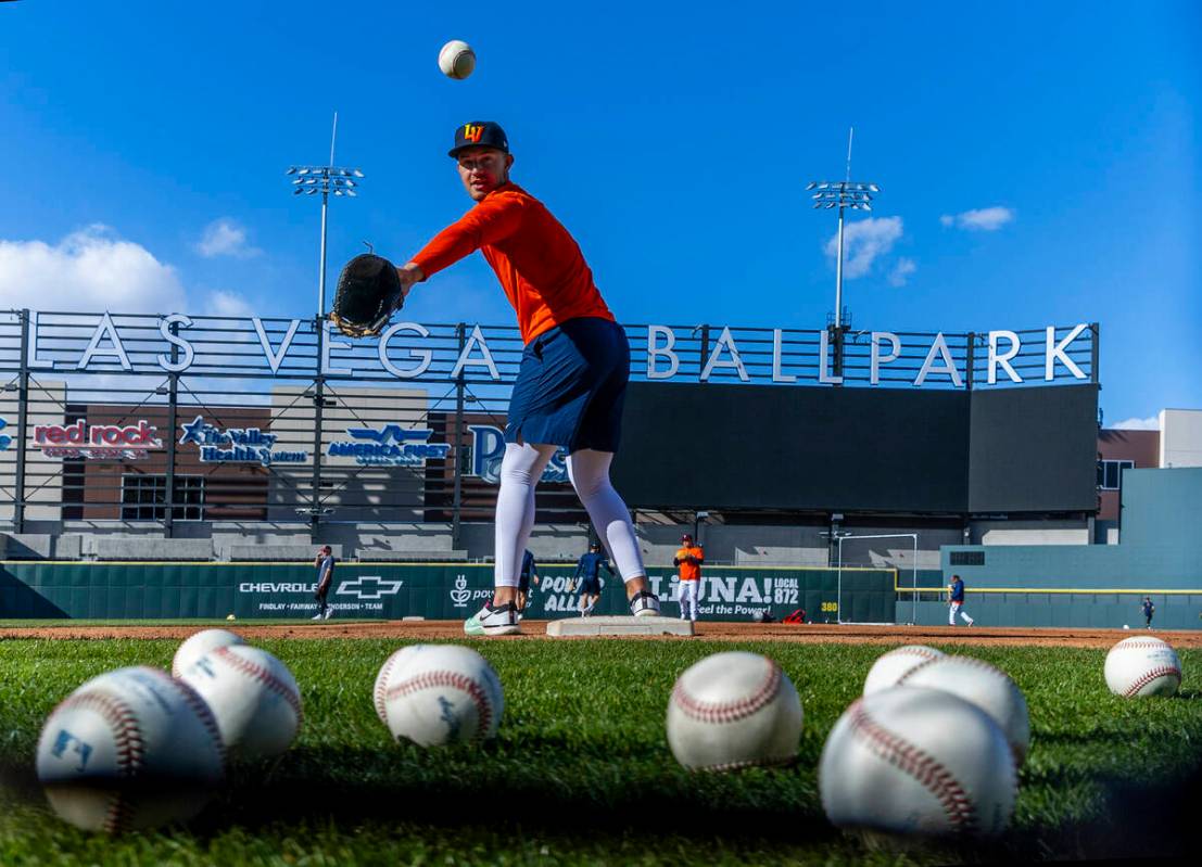 Infielder Drew Lugbauer (17) tosses back another ball while catching balls at first base during ...