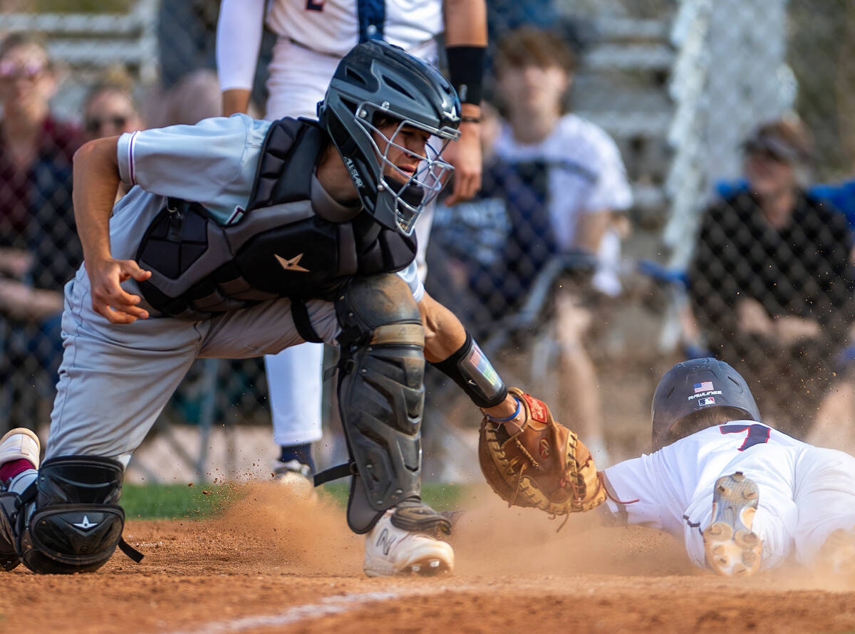 Coronado runner Jackson Thomsen (7) slides safely home beating a tag by Desert Oasis catcher De ...