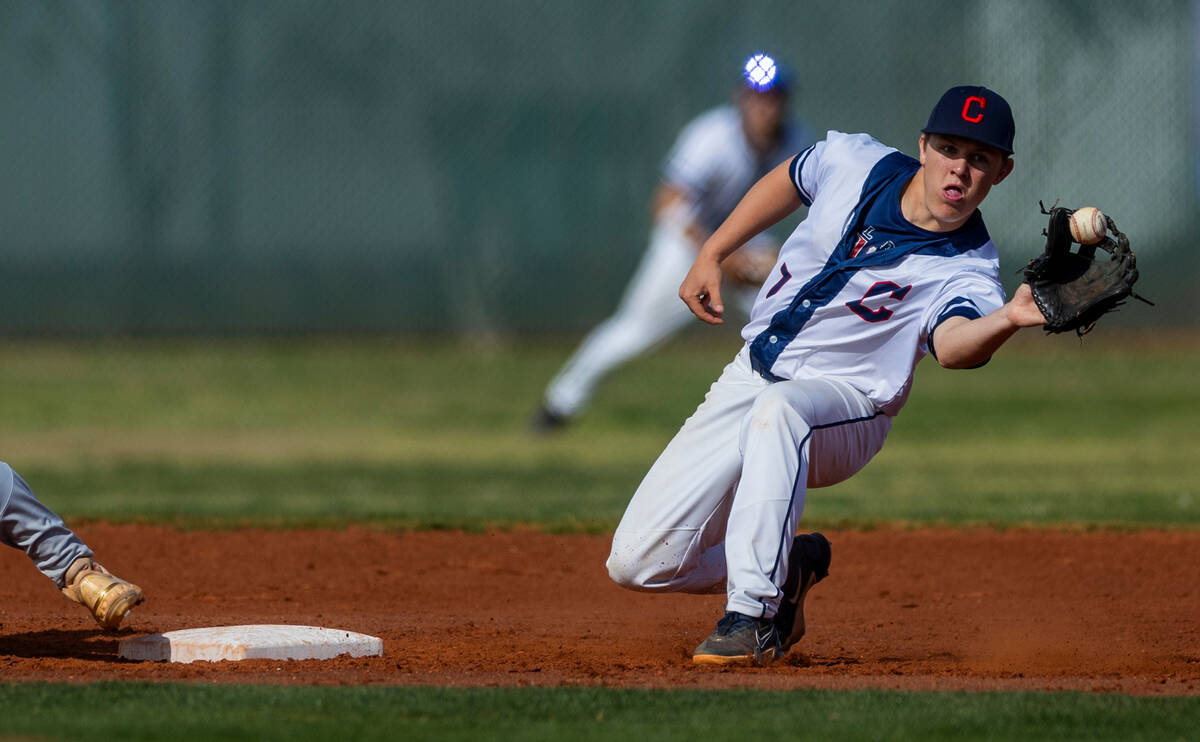 Coronado runner Jackson Thomsen (7) grabs a throw to second base as a Desert Oasis player arriv ...