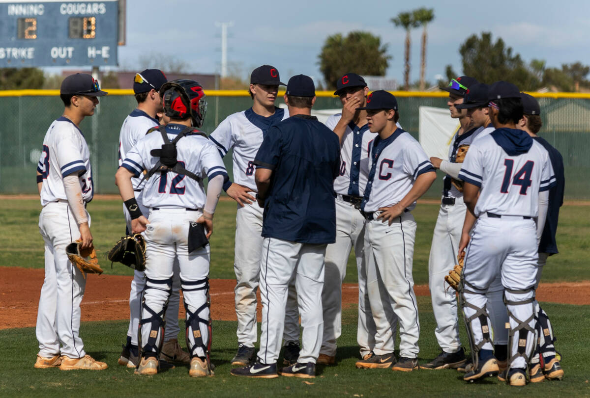 Coronado players gather with a coach during an inning change over against Desert Oasis during t ...