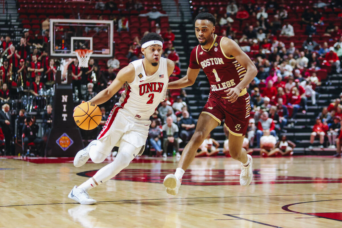UNLV guard Justin Webster (2) drives the ball as Boston College guard Claudell Harris Jr. (1) g ...