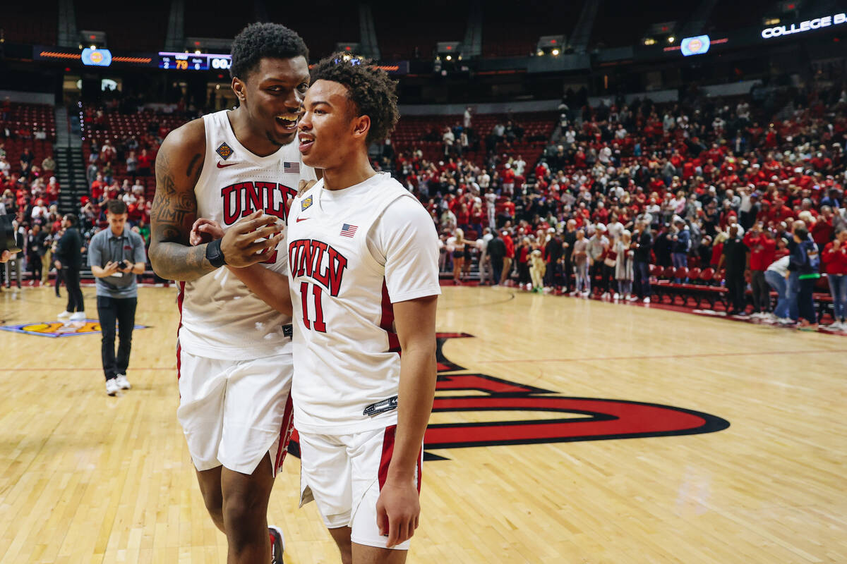 UNLV forward Karl Jones (22) and UNLV guard Dedan Thomas Jr. (11) celebrate after winning a sec ...