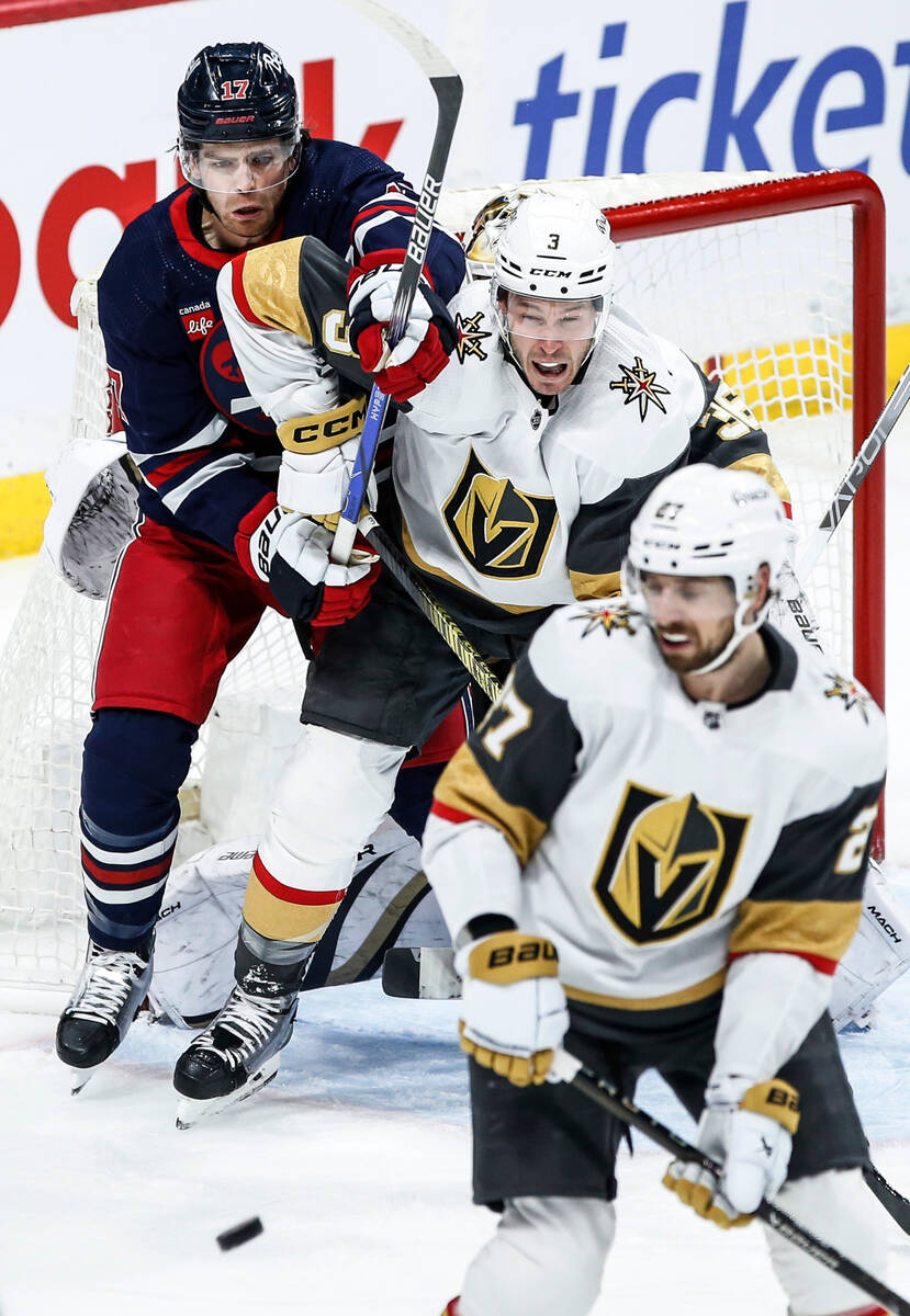 Vegas Golden Knights' Brayden McNabb (3) defends against Winnipeg Jets' Adam Lowry (17) during ...