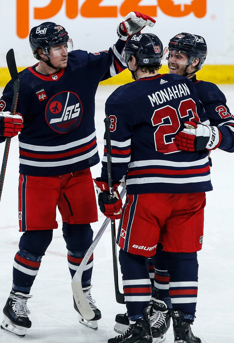 Winnipeg Jets' Tyler Toffoli, Sean Monahan and Nikolaj Ehlers celebrate Monahan's goal against ...