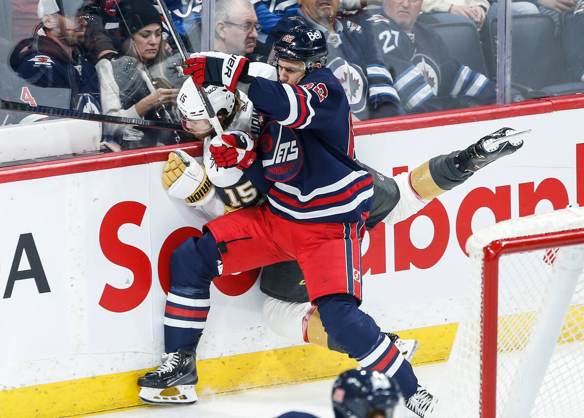 Winnipeg Jets' Nino Niederreiter (62) and Vegas Golden Knights' Noah Hanifin (15) collide durin ...