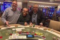 Ghassan Khalaf, left, and friends celebrate a $251,812 pai gow progressive jackpot on Thursday, ...