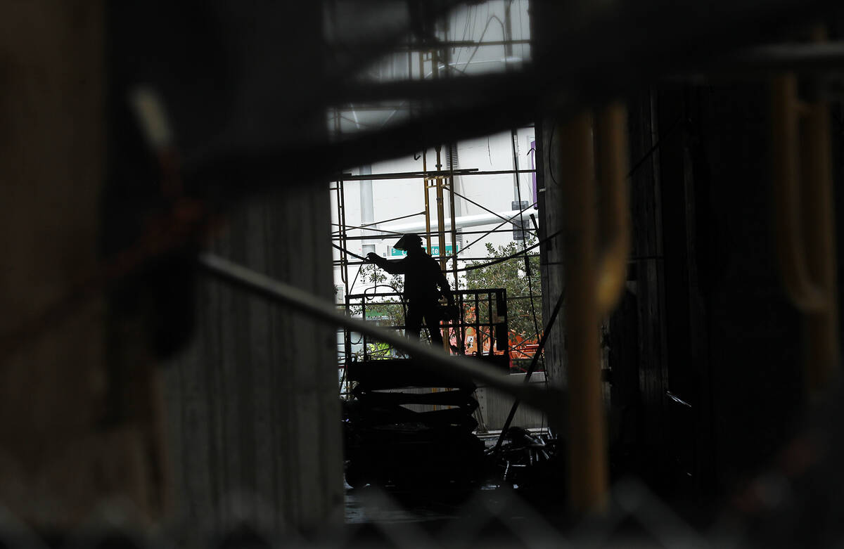 A worker is seen during the demolition of the Harmon Hotel at City Center in Las Vegas on Frida ...