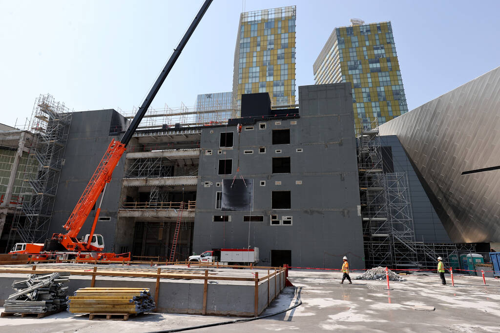Workers dismantle the south core of the former Harmon hotel to make room for a four-story retai ...