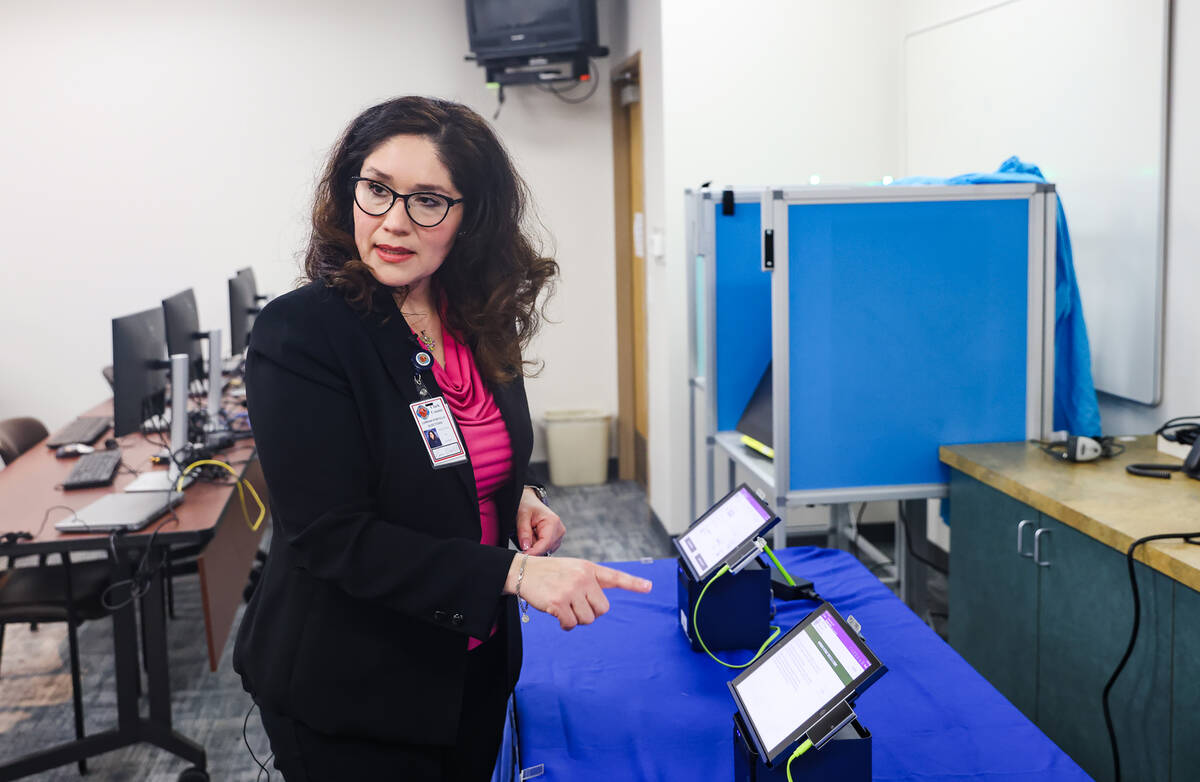 Clark County Registrar Lorena Portillo shows the Review-Journal how an electronic poll pad work ...