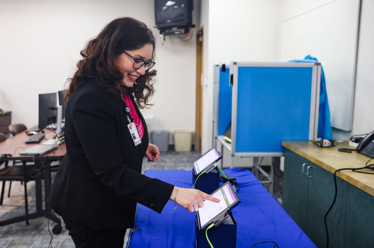 Clark County Registrar Lorena Portillo shows the Review-Journal how an electronic poll pad work ...