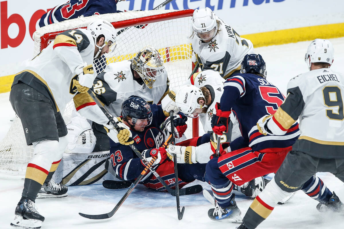 Winnipeg Jets' Tyler Toffoli (73) goes down on Vegas Golden Knights goaltender Logan Thompson's ...