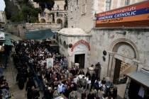 Christians walk the Way of the Cross procession that commemorates Jesus Christ's crucifixion on ...