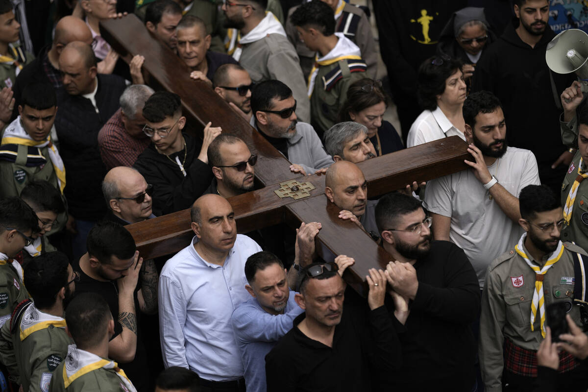 Christians walk the Way of the Cross procession that commemorates Jesus Christ's crucifixion on ...