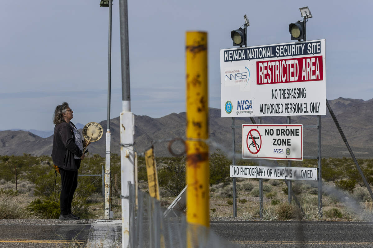 Donna Eyestone of Alameda, Calif., drums and chants at the entrance of the Nevada National Secu ...