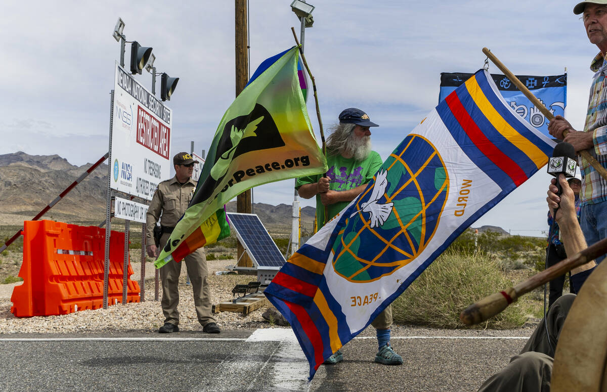 Chris Pinney from Walla Walla, WA., holds a peace flag beside the security line at the entry of ...