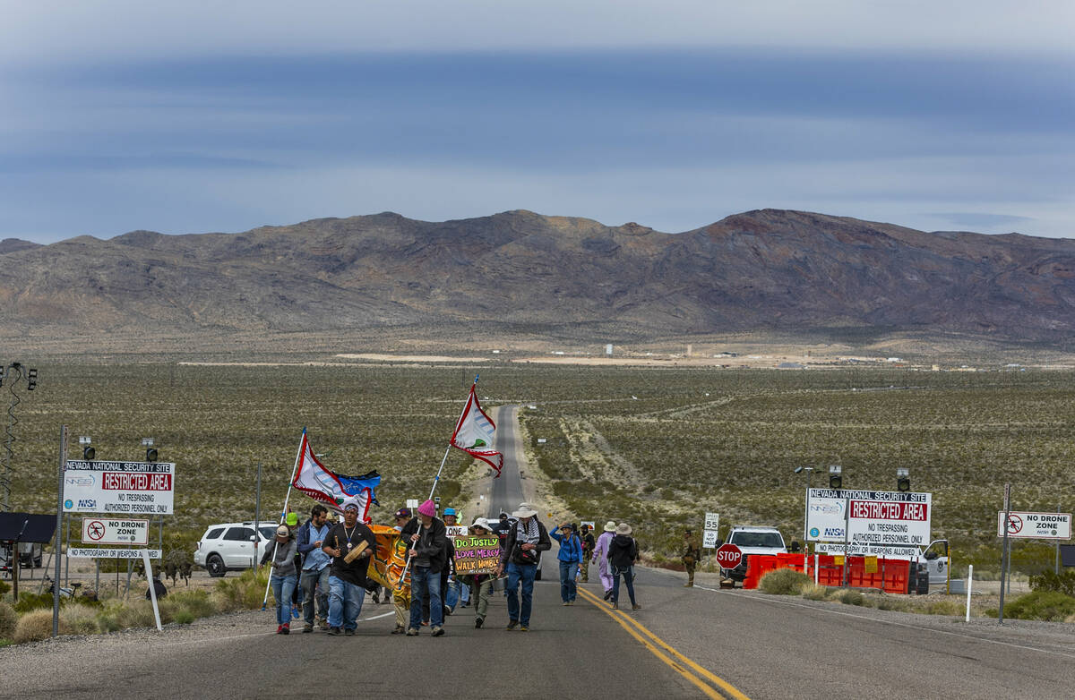 Members of the Nevada Desert Experience conclude their sacred peace walk at the entry of the Ne ...