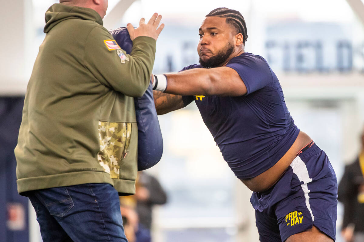 Notre Dame offensive tackle Blake Fisher runs a drill during NFL pro day football workouts in S ...