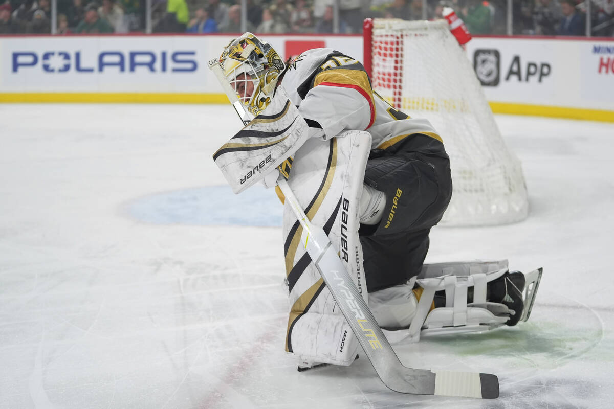 Vegas Golden Knights goaltender Logan Thompson kneels on the ice after a collision during the f ...