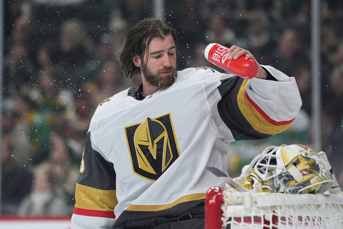 Vegas Golden Knights goaltender Logan Thompson douses his face with water during the first peri ...