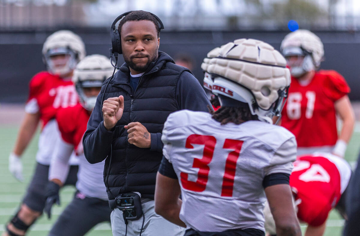 UNLV offensive coordinator Brennan Marion dances as his players stretch during spring football ...