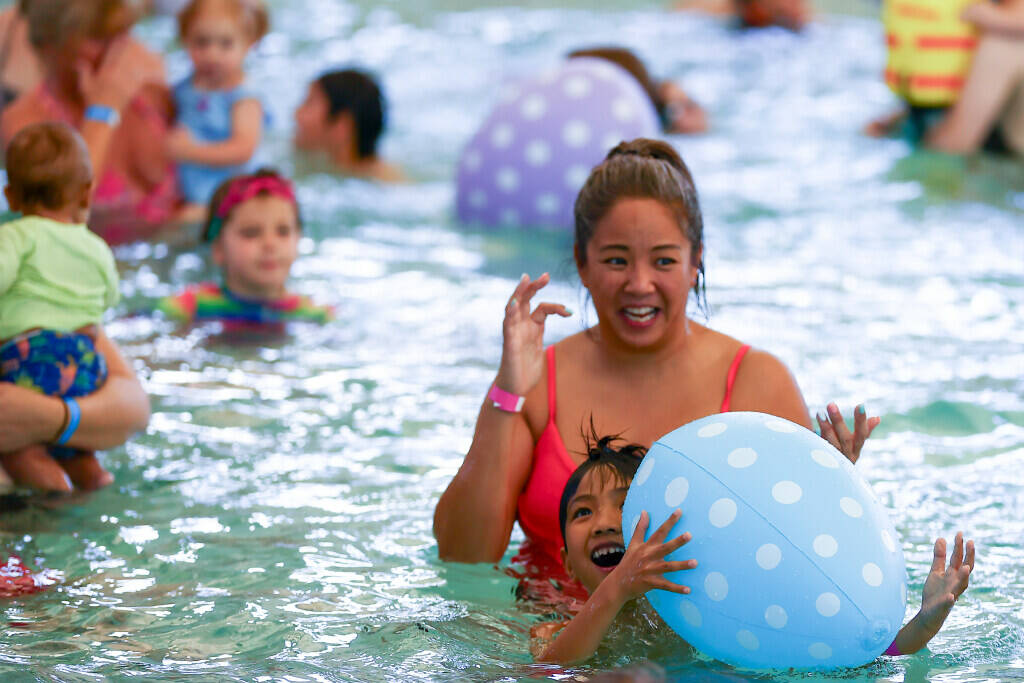 Hunters play with egg-shaped floaty toys during an Easter egg dive at Heritage Park Aquatic Com ...