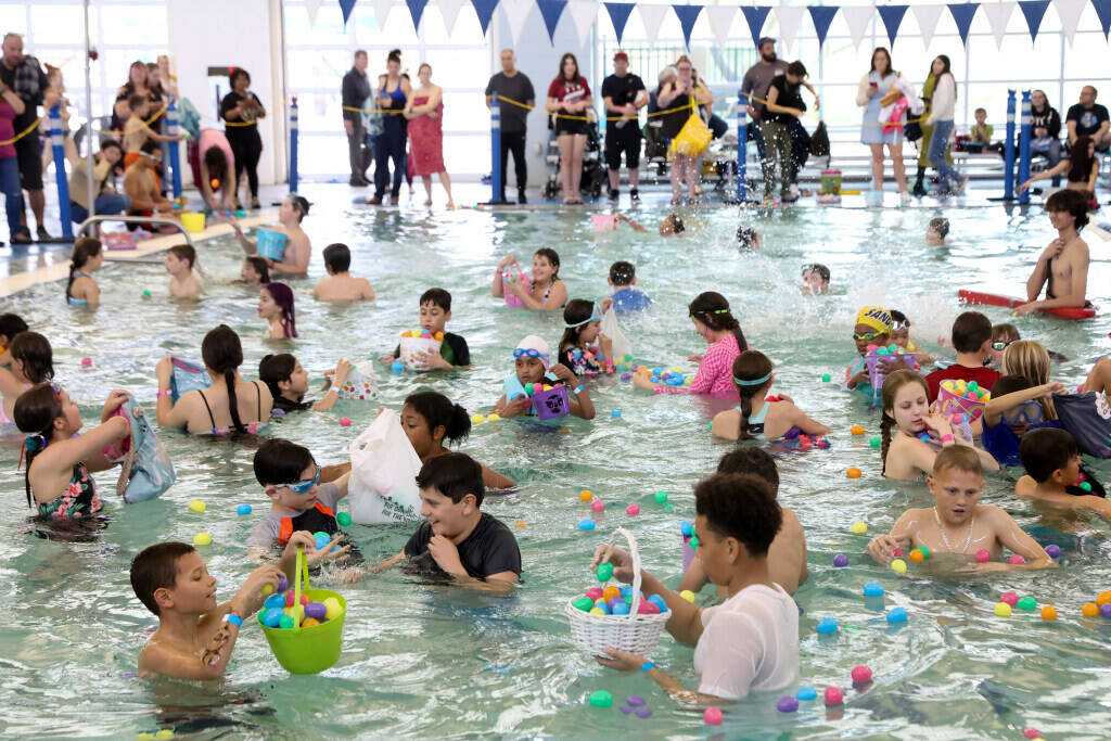 Hunters plunge for prizes during an Easter egg dive at Heritage Park Aquatic Complex on Sunday, ...