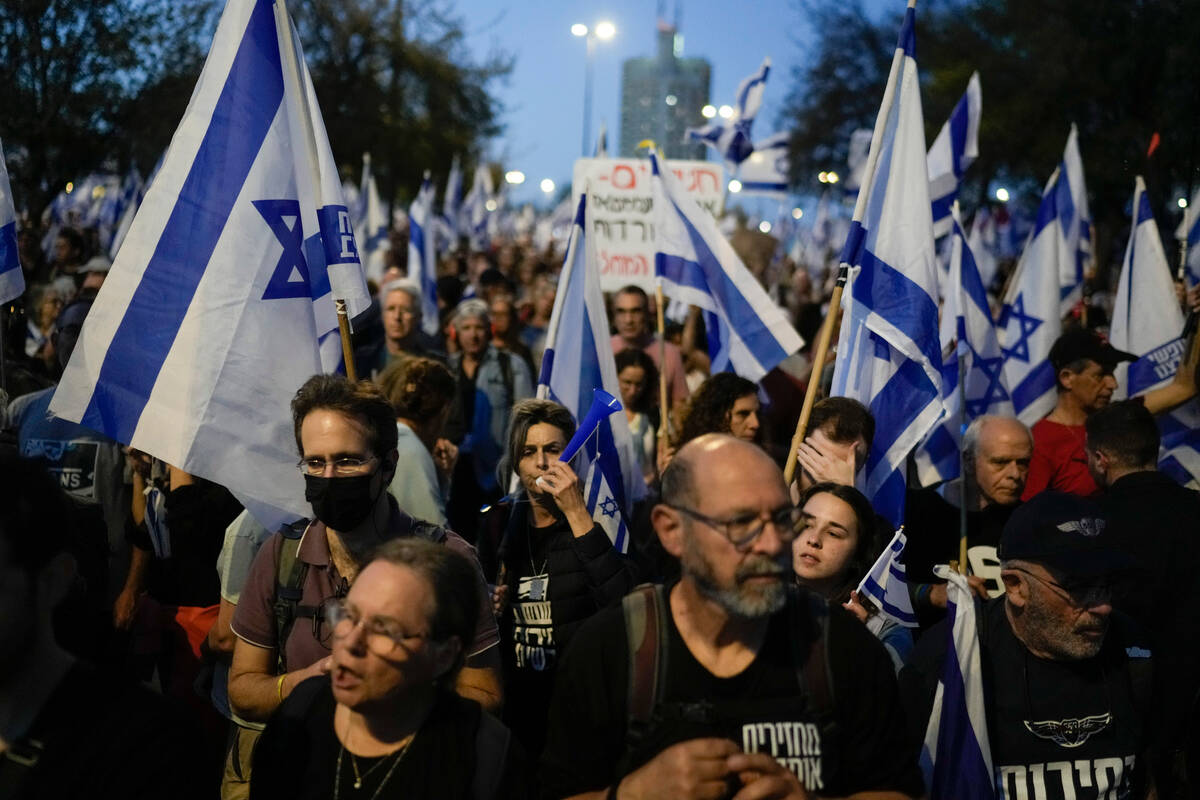 People take part in a protest against Israeli Prime Minister Benjamin Netanyahu's government an ...