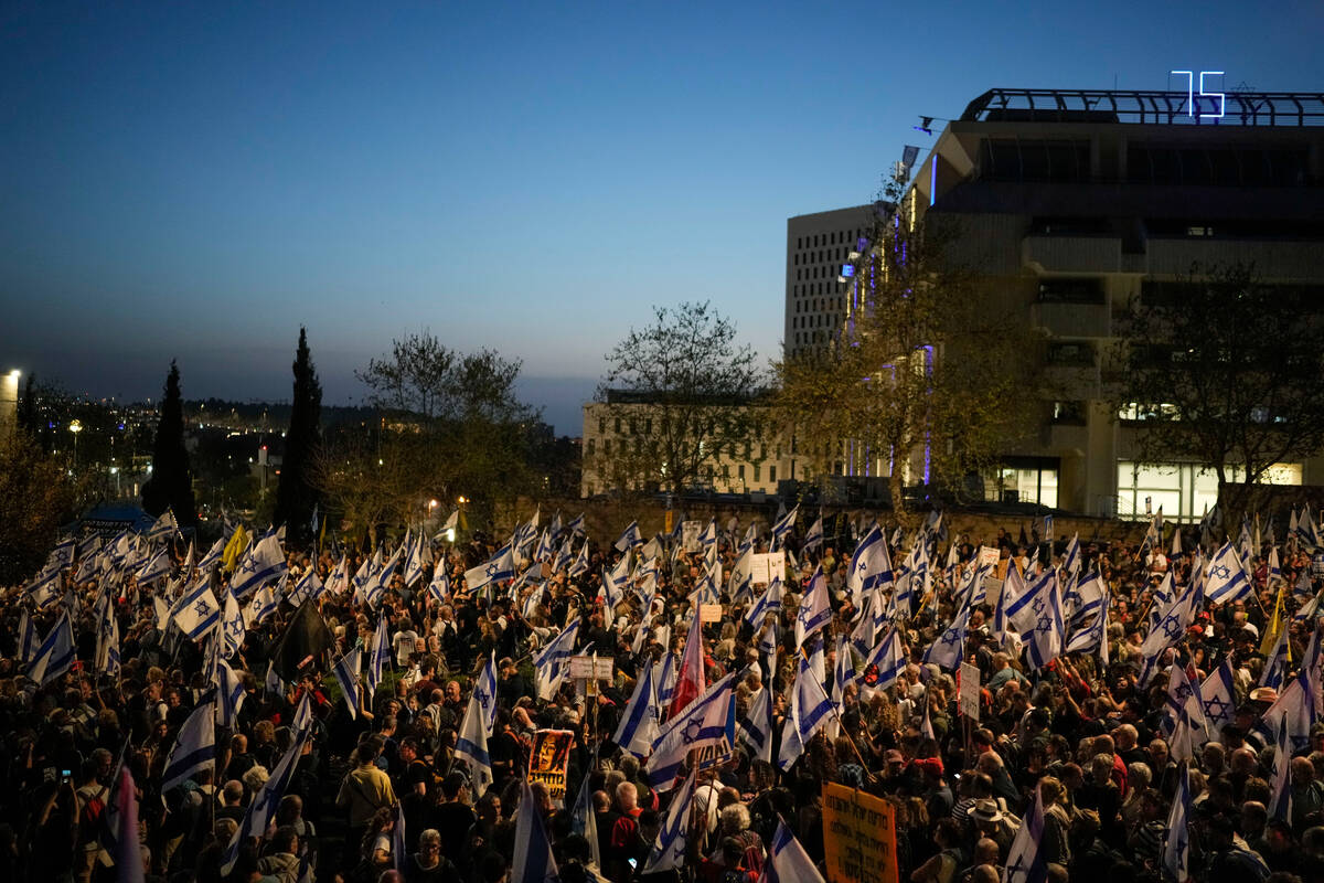People take part in a protest against Israeli Prime Minister Benjamin Netanyahu's government an ...