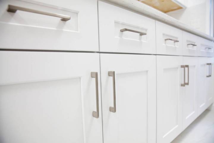 You can dress up your cabinets by installing distinctive knobs or pulls. (Getty Images)