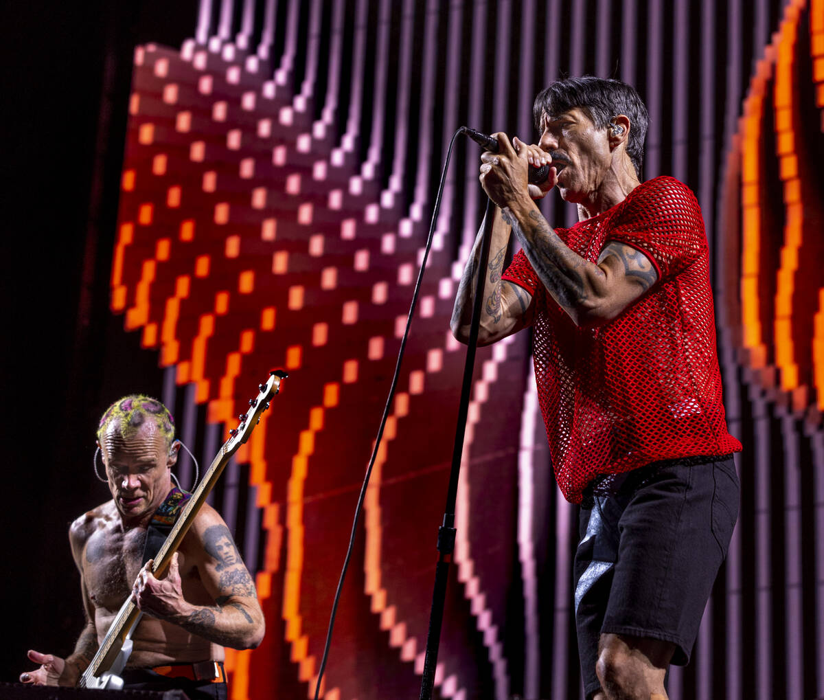 (From left) Bassist Flea plays as Lead singer Anthony Kiedis sings with The Red Hot Chili Peppe ...