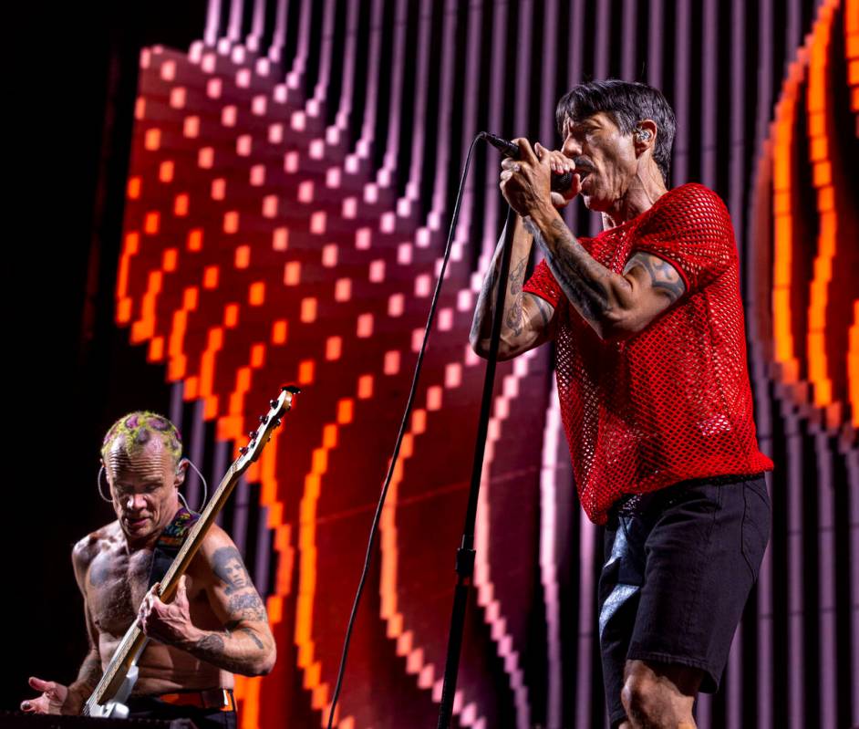 (From left) Bassist Flea plays as Lead singer Anthony Kiedis sings with The Red Hot Chili Peppe ...