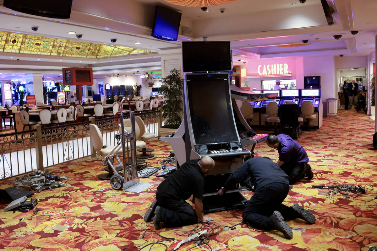 Workers prepare to remove gaming machines on the final day of the Tropicana on the Strip in Las ...