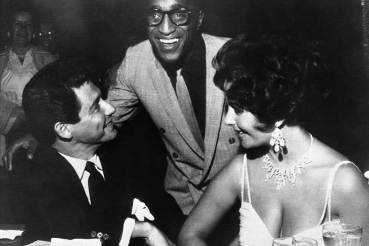 Elizabeth Taylor, right, and Eddie Fisher, left, discuss wedding plans with Sammy Davis Jr. sho ...
