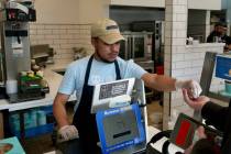 An employee collects payment at an Auntie Anne's and Cinnabon store in Livermore, Calif., Thurs ...