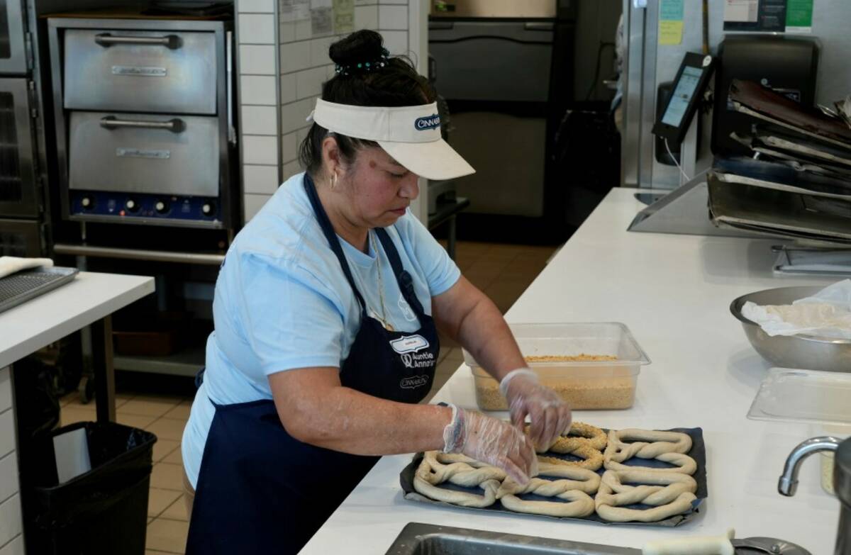 An employee makes pretzels at an Auntie Anne's and Cinnabon store in Livermore, Calif., Thursda ...