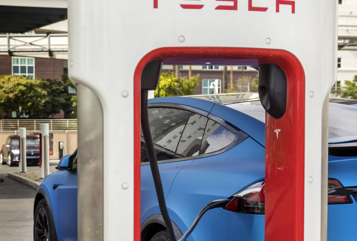 A car is plugged in at the Tesla Supercharger station near The LINQ and High Roller on Friday, ...