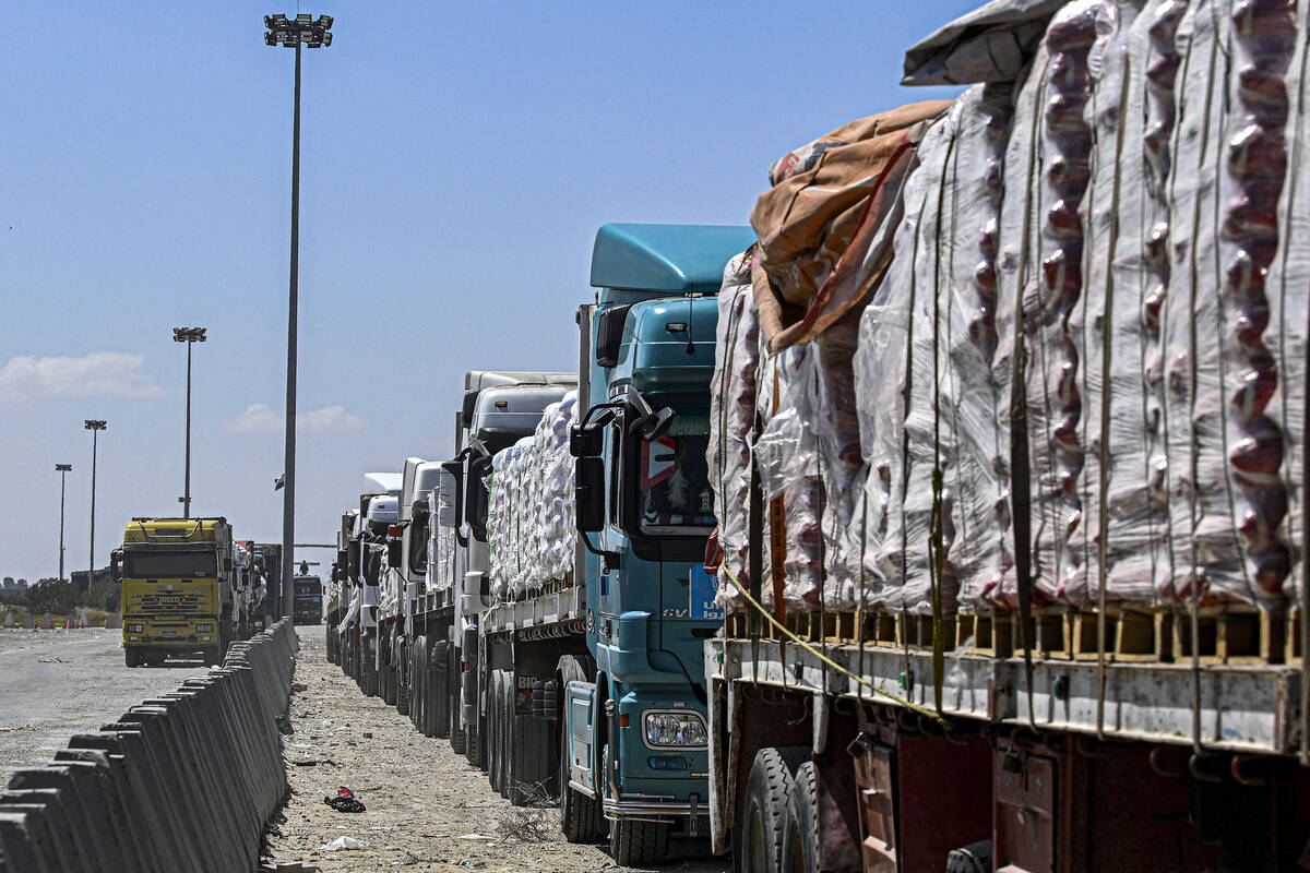 Egyptian trucks carrying humanitarian aid bound for the Gaza Strip queue outside the Rafah bord ...