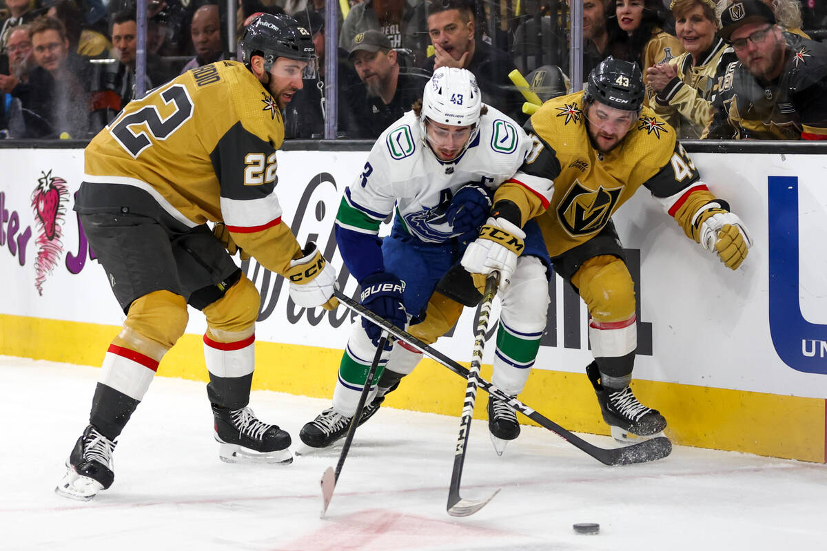 Golden Knights right wing Michael Amadio (22) and center Paul Cotter (43) pressure the puck awa ...