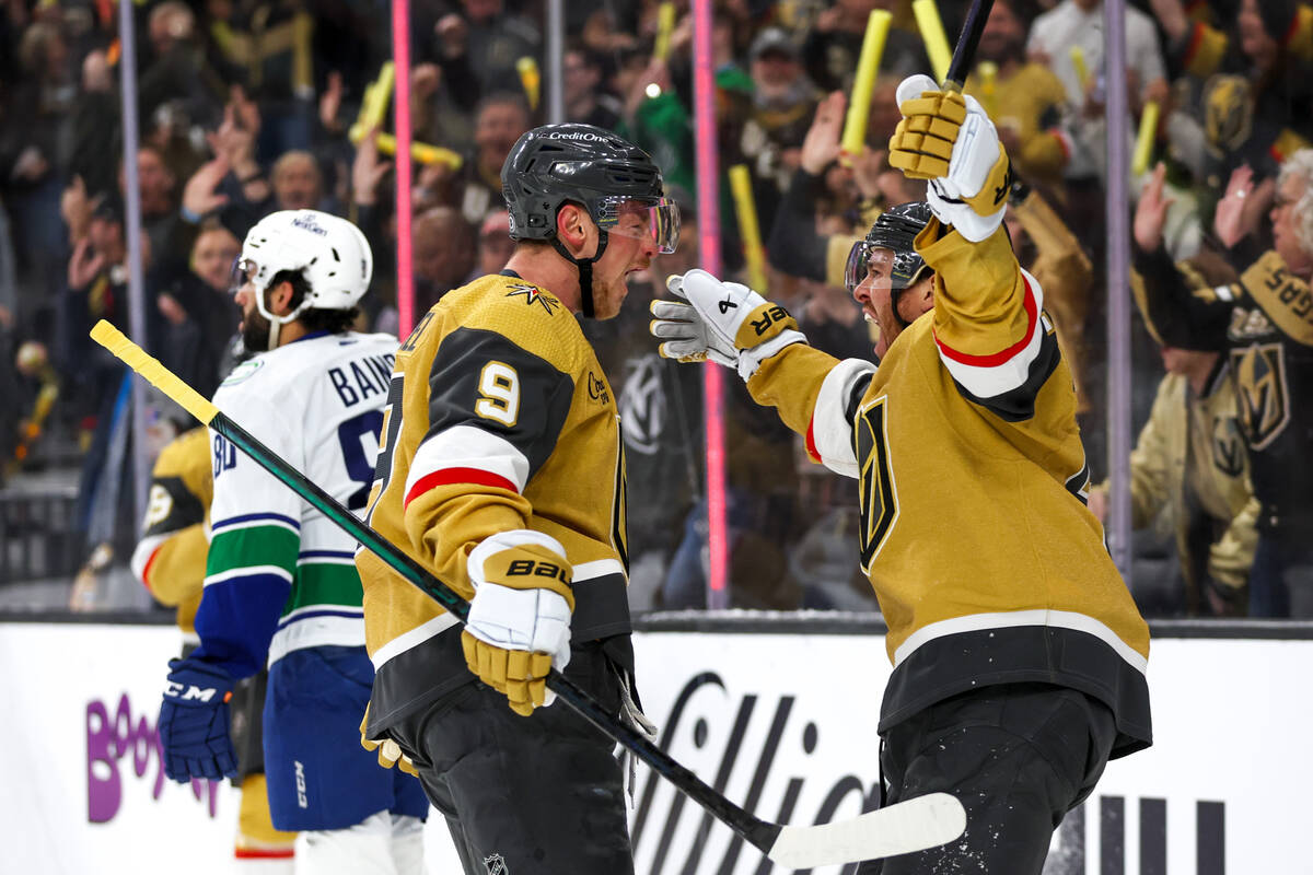 Golden Knights center Jack Eichel (9) and right wing Jonathan Marchessault (81) celebrate a sco ...