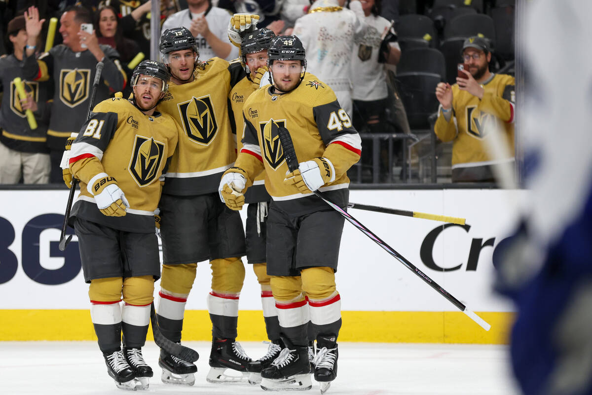 The Golden Knights celebrate after defenseman Noah Hanifin (15) scored during the first period ...