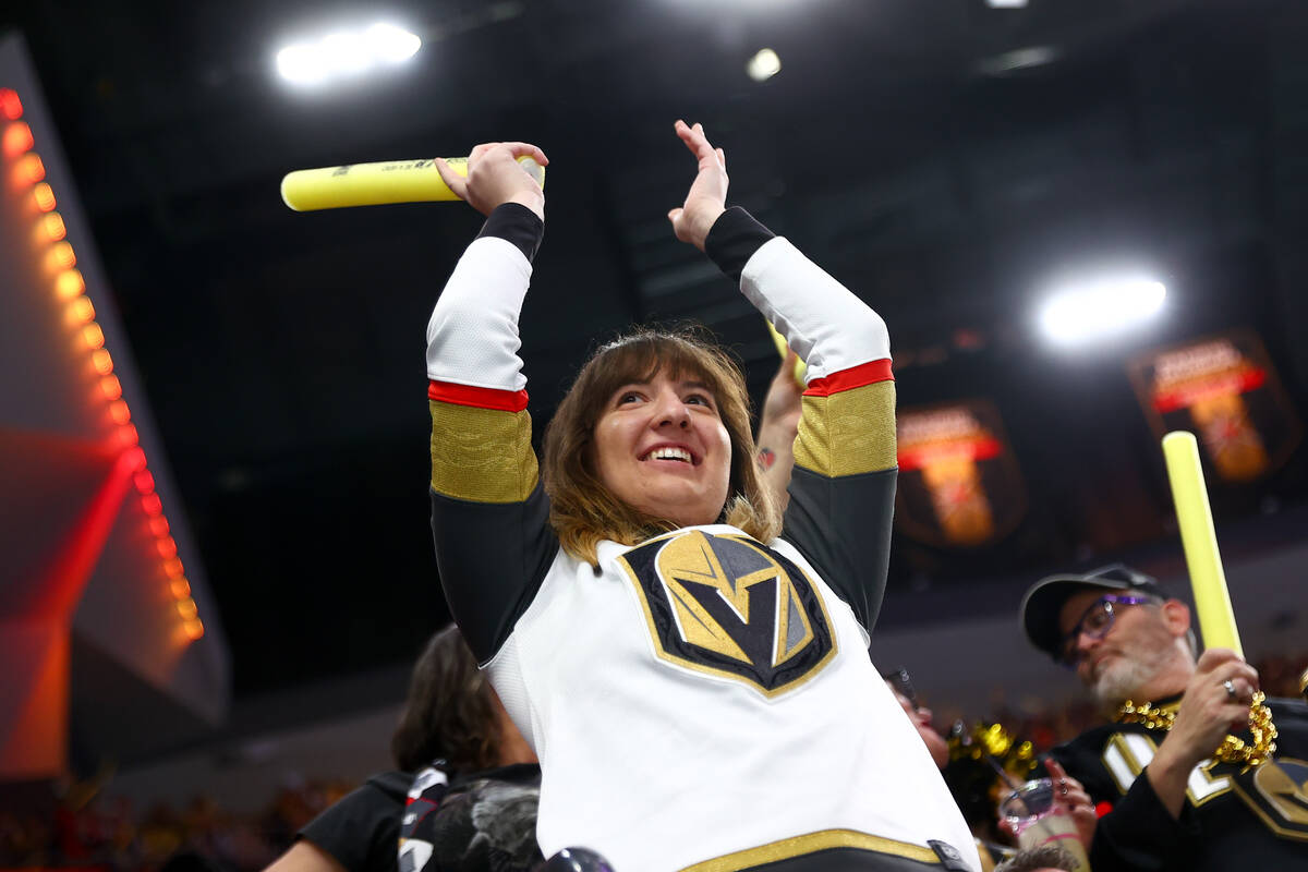 A Golden Knights fan celebrates a goal during the first period of an NHL hockey game against th ...