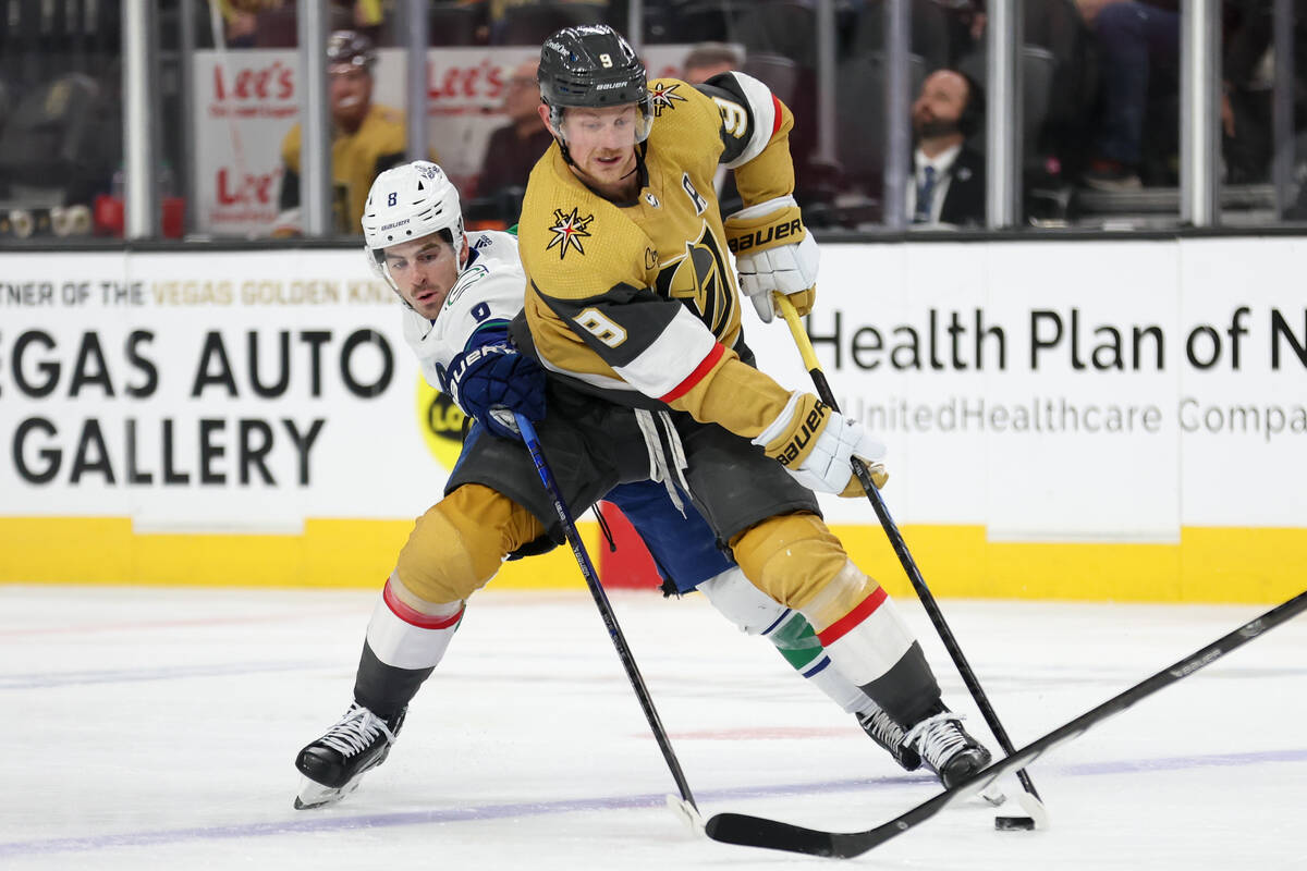 Golden Knights center Jack Eichel (9) skates with the puck against Canucks right wing Conor Gar ...