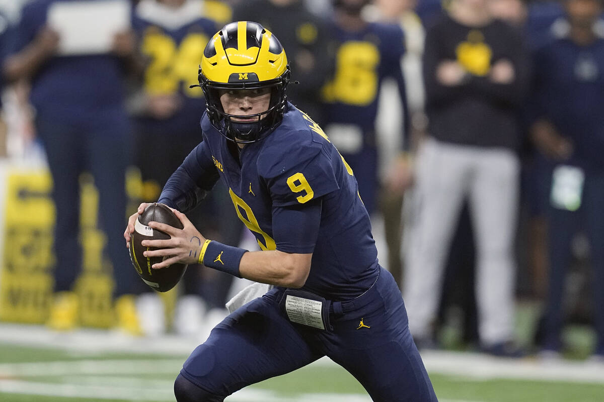 Michigan quarterback J.J. McCarthy drops back to pass during the first half of the Big Ten cham ...