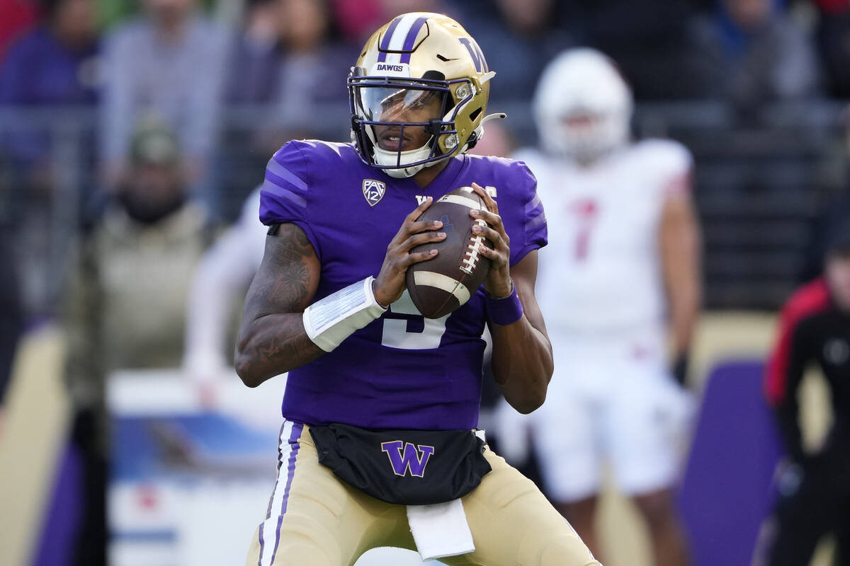 Washington quarterback Michael Penix Jr. (9) looks to pass during the first half of an NCAA col ...