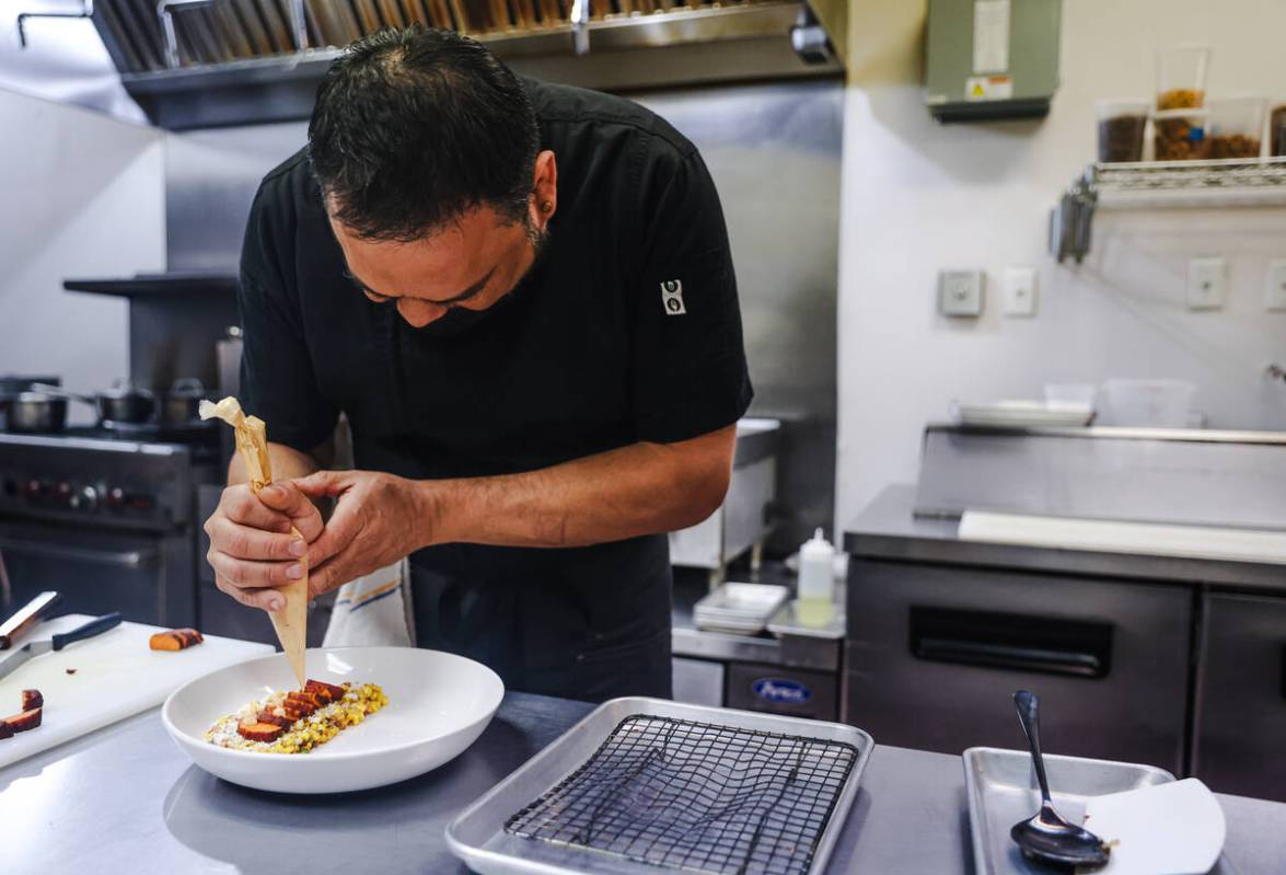 Chef and owner Steve Kestler prepares beef short ribs with mole, roasted sweet potatoes and esq ...